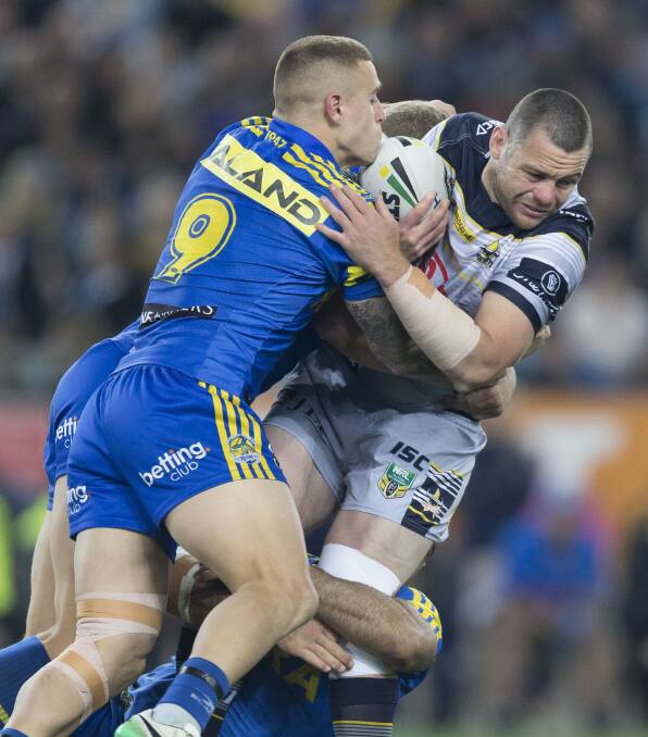 Cameron King of the Eels tackles Shaun Fensom of the Cowboys during the NRL semi-final. (AAP Image/Craig Golding)