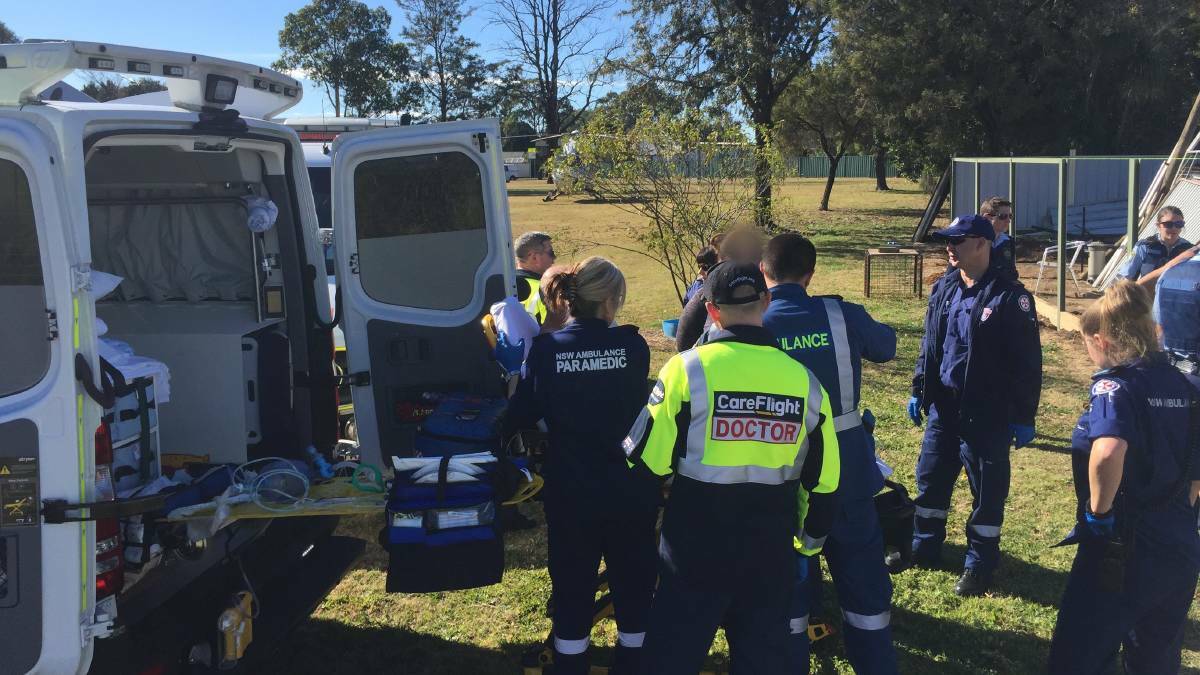 Paramedics treat a man who had sustained serious neck wounds while repairing a fence at North St Marys in August. Picture: CareFlight