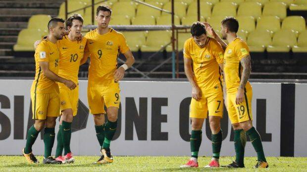 Strong first half: Teammates congratulate Robbie Kruse (10) after his opening goal. Photo: AP