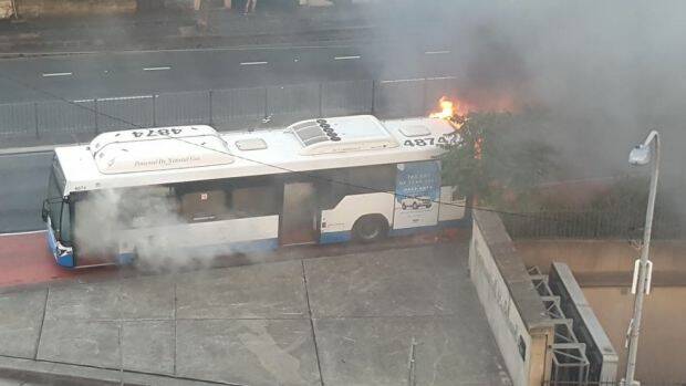 A bus caught on fire in Surry Hills on Monday on Flinders Street.  Photo: Phil Dye