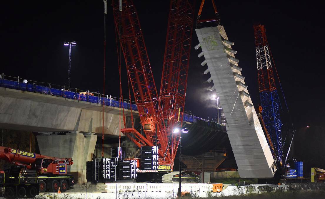 PRECISION: Cranes lifted the 29-metre steel tower on to the top of the bridge.