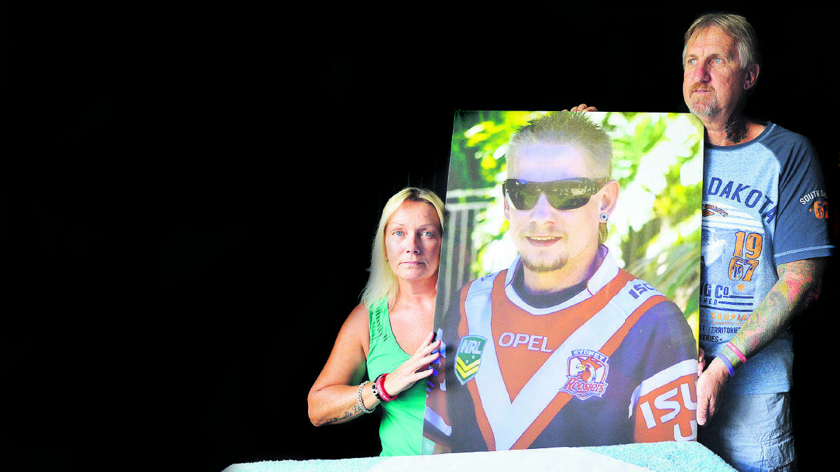 FUNDRAISER: Donna and Paul Stevens with a picture of Steven in his beloved Roosters jumper.	Picture by STUART SCOTT