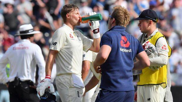 Safety first: Joe Root hydrates during one of the many drinks breaks on day four of the Test played in extreme heat. Photo: Andy Brownbill