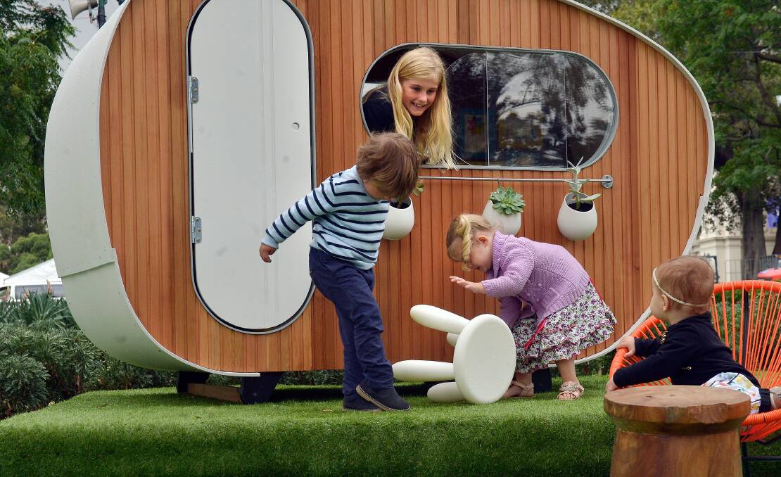 In the cubby-Celeste Mei (9), pink-Daisy Mei  (2) , strips-Lachlan Thomas (3) and Eden Thomas (1). Cubby house challenge at the Melbourne garden show. 24th of March 2014 The Age news Picture by JOE ARMAO