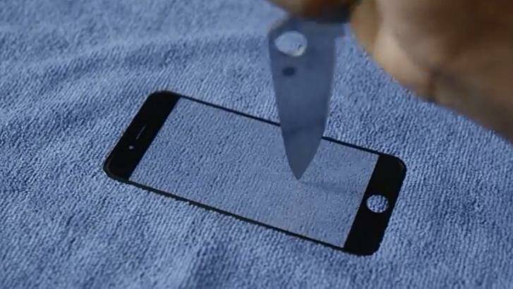 Youtube user Marques Brownlee takes a knife to a screen he claimed was going to be used in iPhone 6. Photo: YouTube