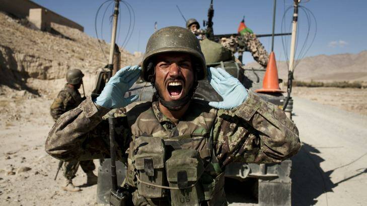 Afghan soldiers carry out a controlled detonation of a roadside bomb in Wardak province. Photo: New York Times