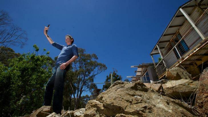 Brendan Hehir checks for a mobile phone signal at his Blackwood house. Photo: Jason South