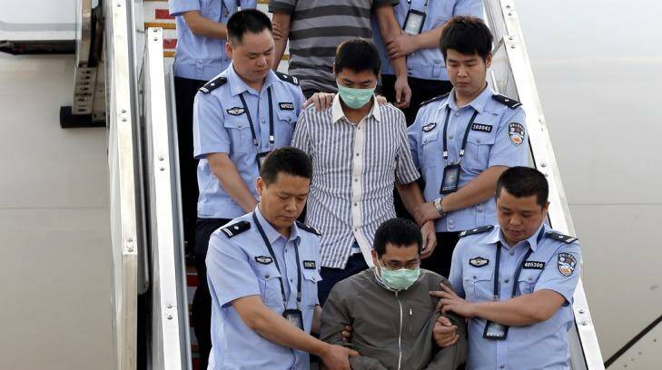 Six fugitives accused of economic crimes are taken back to China under escort from Indonesia in June 2015 as part of Operations Fox Hunt and Skynet. Photo: Xinhua/AP