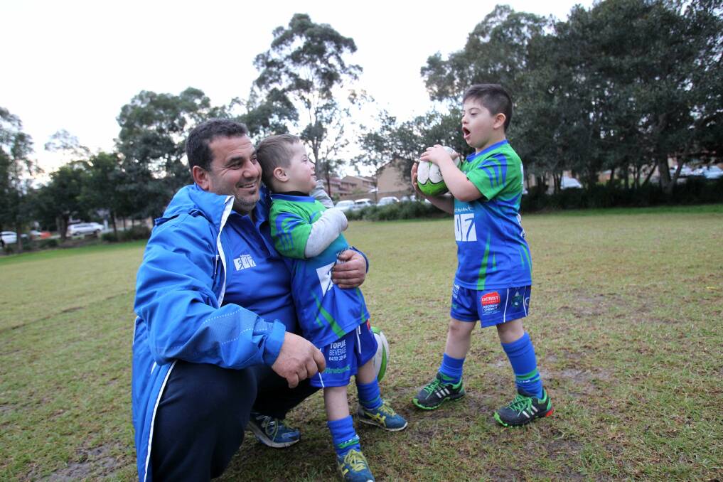 Try time: Tony Bainou with Kassem Farhat, 5, and Ayoub Elfata, 8, who he coaches as part of the Parramatta City Titans, Try Time program for kids with special needs. Picture: Gene Ramirez