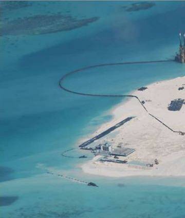 A February 2014 photo taken by surveillance planes for the Philippines government shows Chinese construction work on Johnson Reef in the disputed Spratly Islands.  Photo: Philippines Department of Foreign Affairs
