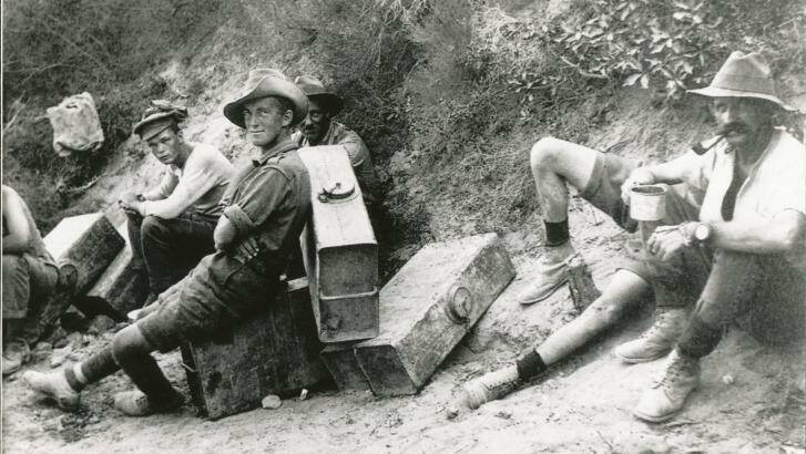 Men of the 6th Field Battery on water-carrying fatigues stop for a rest and a smoke.  Photo: From 'Anzac & Empire'. 