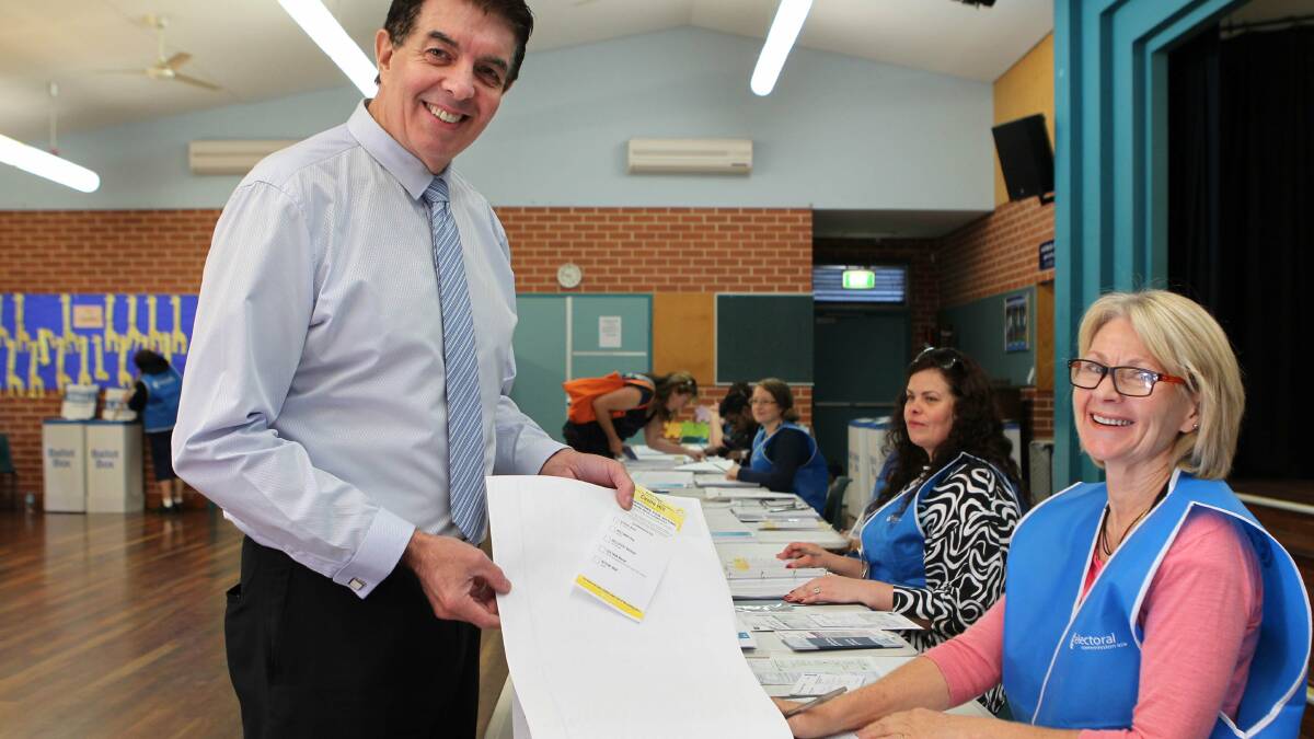 Castle Hill Liberal candidate Ray Williams (current Hawkesbury MP) receiving his ballot papers from Election Official Alison Baker at Rouse Hill Public School. Ray has swapped electorates with current Castle Hill MP Dominic Perrottet. Photo: Helen Nezdropa