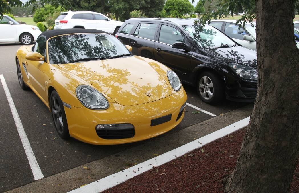 Mysteriously dumped: This uninsured and unregistered yellow Porsche was left in the Castlebrook Cemetery car park a day after it was allegedly used to do burnouts in the top grassed area, near Kellyville Road, where there are no memorials. Picture: Natalie Roberts