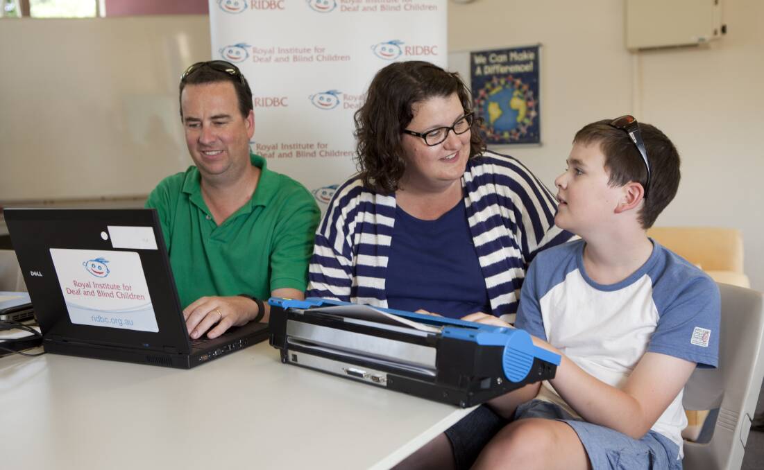 Pictured are Julian and Michelle with their son Charlie using the UEB Online system.