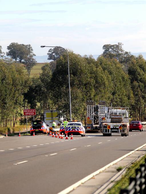 Truck drivers being pulled over at Box Hill this morning. Pictures: Isabella Lettini