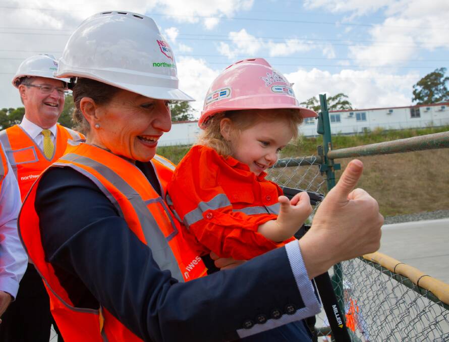 Thumbs up: Four-year-old Isabelle Andersen giving the go ahead for the third TBM named Isabelle to start drilling, with Transport Minister Gladys Berejiklian.