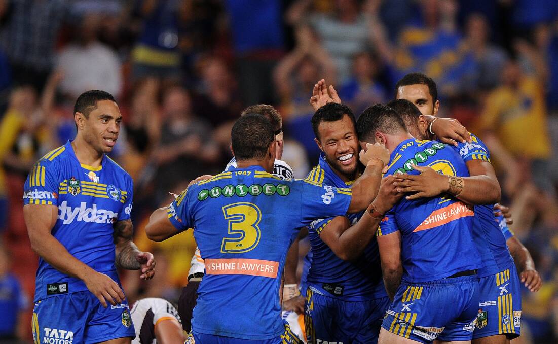 BRISBANE, AUSTRALIA - APRIL 04: Nathan Peats (obscured) of the eels celebrates scoring a try with team-mates during the round five NRL match between the Brisbane Broncos and Parramatta Eels at Suncorp Stadium on April 4, 2014 in Brisbane, Australia. (Photo by Matt Roberts/Getty Images)