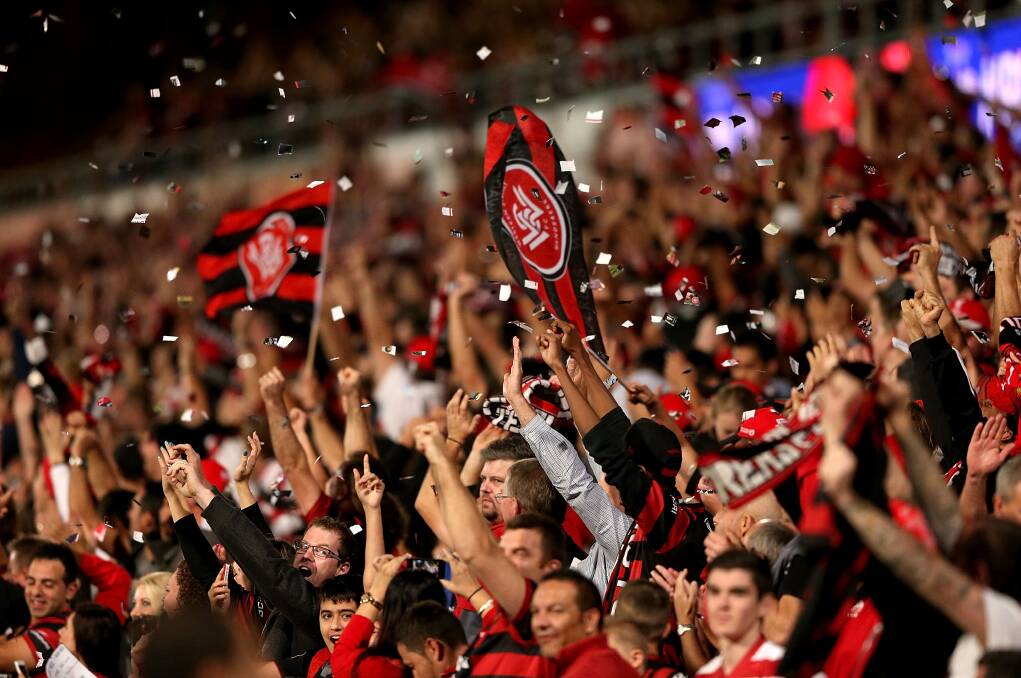 SYDNEY, AUSTRALIA - APRIL 26: Western Sydney Wanderers fans celebrate winning during the A-League Semi Final match between the Western Sydney Wanderers and the Central Coast Mariners at Pirtek Stadium on April 26, 2014 in Sydney, Australia. (Photo by Ashley Feder/Getty Images)