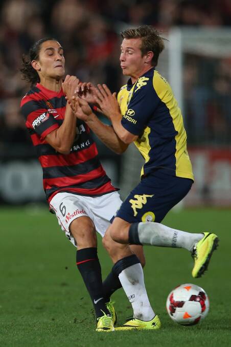 SYDNEY, AUSTRALIA - APRIL 26: Jerome Polenz of the Wanderers and Nick Fitzgerald of the Mariners compete for the ball during the A-League Semi Final match between the Western Sydney Wanderers and the Central Coast Mariners at Pirtek Stadium on April 26, 2014 in Sydney, Australia. (Photo by Mark Kolbe/Getty Images)