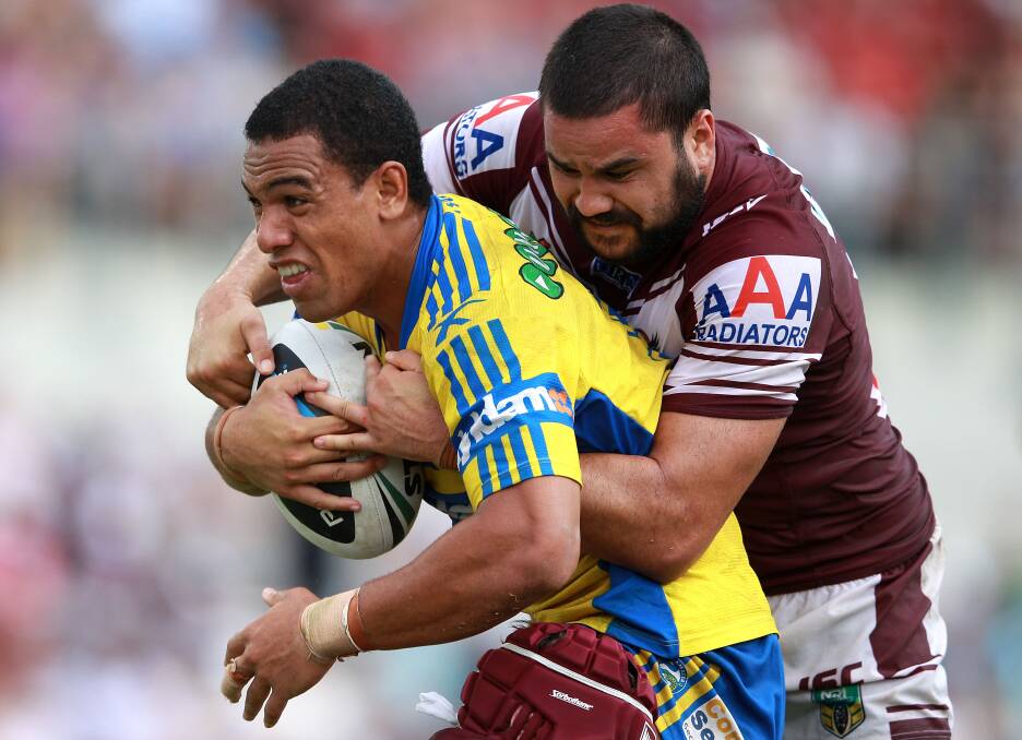 SYDNEY, AUSTRALIA - MARCH 23: Will Hopoate of the Eels is tackled during the round three NRL match between the Manly-Warringah Sea Eagles and the Parramatta Eels at Brookvale Oval on March 23, 2014 in Sydney, Australia. (Photo by Matt Blyth/Getty Images)