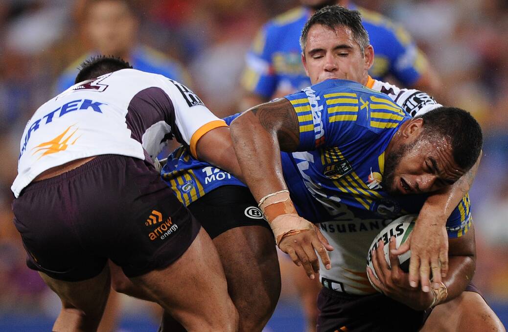 BRISBANE, AUSTRALIA - APRIL 04: Junior Paulo of the Eels is tackled during the round five NRL match between the Brisbane Broncos and Parramatta Eels at Suncorp Stadium on April 4, 2014 in Brisbane, Australia. (Photo by Matt Roberts/Getty Images)