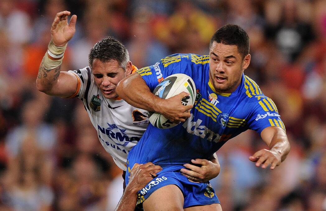 BRISBANE, AUSTRALIA - APRIL 04: Jarryd Hayne of the Eels is tackled during the round five NRL match between the Brisbane Broncos and Parramatta Eels at Suncorp Stadium on April 4, 2014 in Brisbane, Australia. (Photo by Matt Roberts/Getty Images)