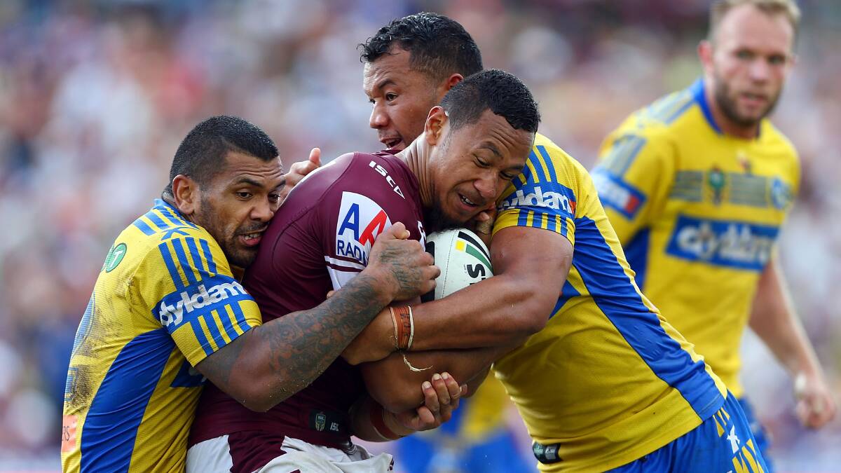 SYDNEY, AUSTRALIA - MARCH 23: Tony Satini of Manly is tackle by Manu Ma'u and Joseph Paulo during the round three NRL match between the Manly-Warringah Sea Eagles and the Parramatta Eels at Brookvale Oval on March 23, 2014 in Sydney, Australia. (Photo by Renee McKay/Getty Images)
