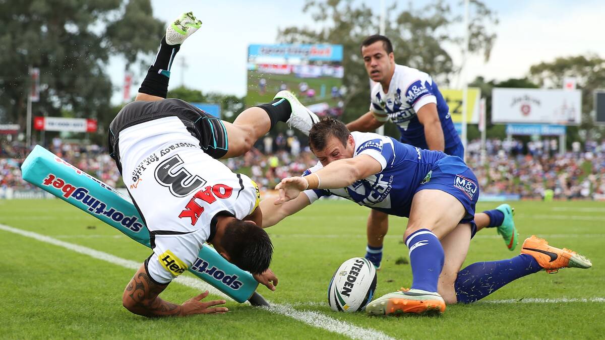 SYDNEY, AUSTRALIA - MARCH 22: Dean Whare of the Panthers dives to score a try as he is challenged by Josh Morris of the Bulldogs during the round three NRL match between the Penrith Panthers and the Canterbury-Bankstown Bulldogs at Sportingbet Stadium on March 22, 2014 in Sydney, Australia. (Photo by Mark Metcalfe/Getty Images)