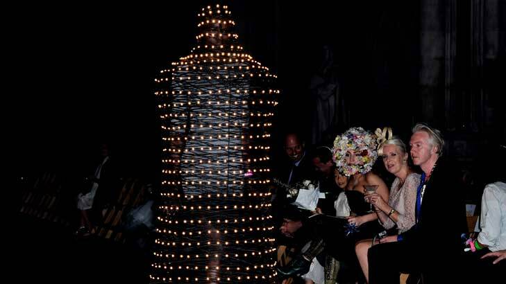 Lady Gaga watches on at  Phillip Treacy's London Fashion Week show. Her floral number had some tough competition on the runway - here, a walking light fitting.