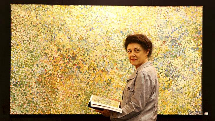 Bettina MacAulay, from St Lucia, inspects Emily Kngwarreye's "Summer Rains on Alalgura, 1991", which is part of Ross and Rona Clarke's private art collection up for auction.