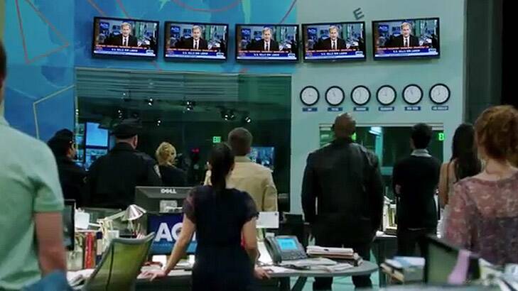 Production staff look on as anchor Will McAvoy (Jeff Daniels) announces the killing of Osama bin Laden on <i>The Newsroom</i>.