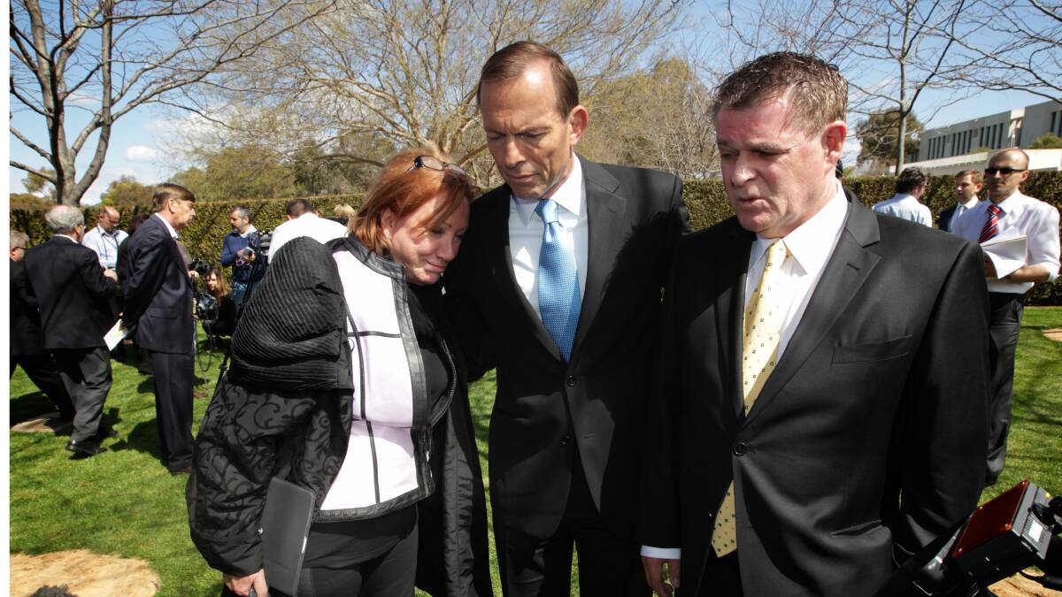 Opposition Leader Tony Abbott meets with Clair Marsh (left) and Peter Hughes (right) at the Bali Memorial Garden in Canberra. Photo: ALEX ELLINGHAUSEN