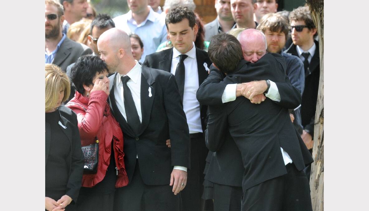 Jill Meagher's mother Edith and (from left) brother Micheal, father George and husband Tom watch doves fly after today's funeral. Photo: JUSTIN McMANUS